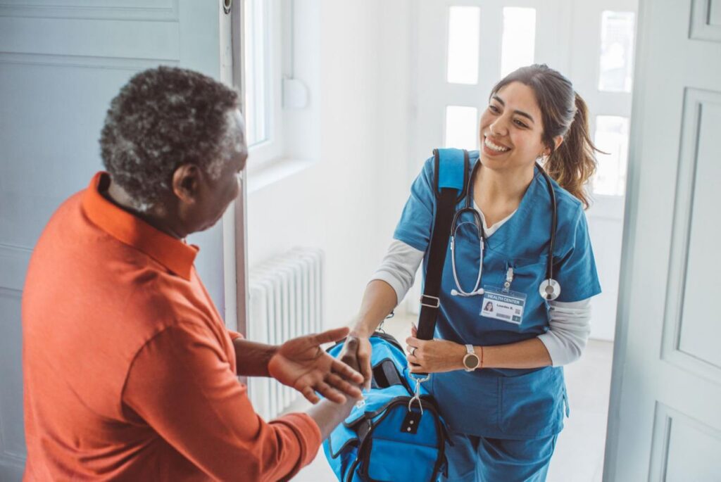 Healthcare worker greeting a patient at home.